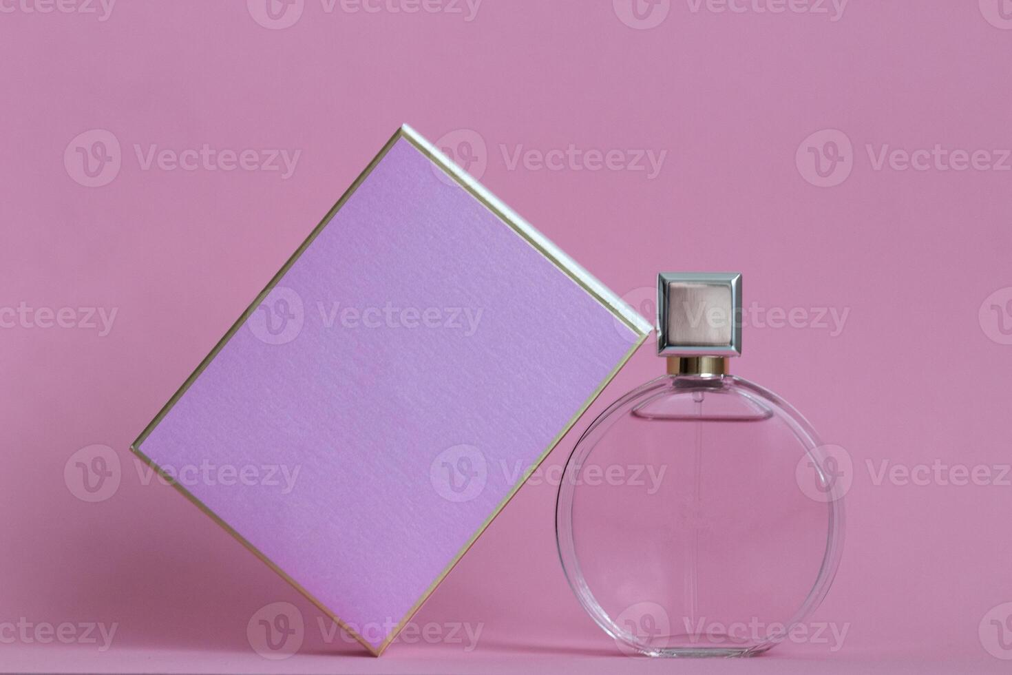 Perfume bottle from a pink box on an isolated background with mockup and copyspace photo