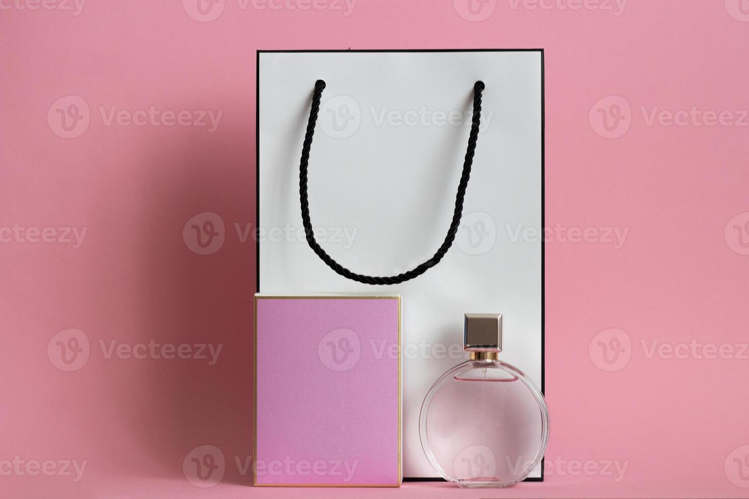 Perfume bottle from a pink box on an isolated background with mockup and copyspace photo