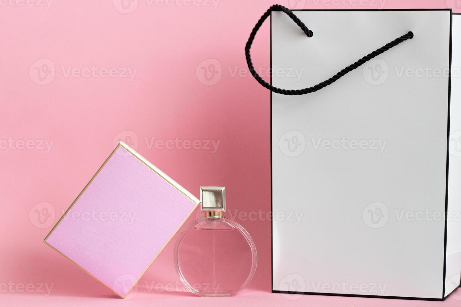 Perfume bottle from a pink box on an isolated background with mockup and copyspace photo