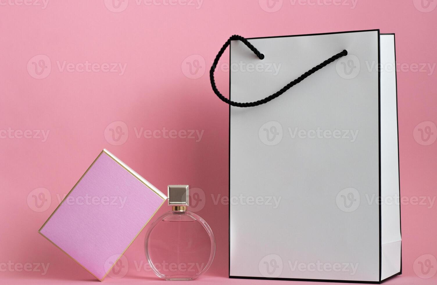 Perfume bottle from a pink box on an isolated background with mockup and copyspace photo