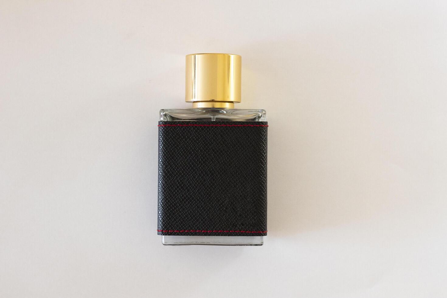 Men's perfume close-up on a white isolated background. Men's perfume in black with copyspace photo