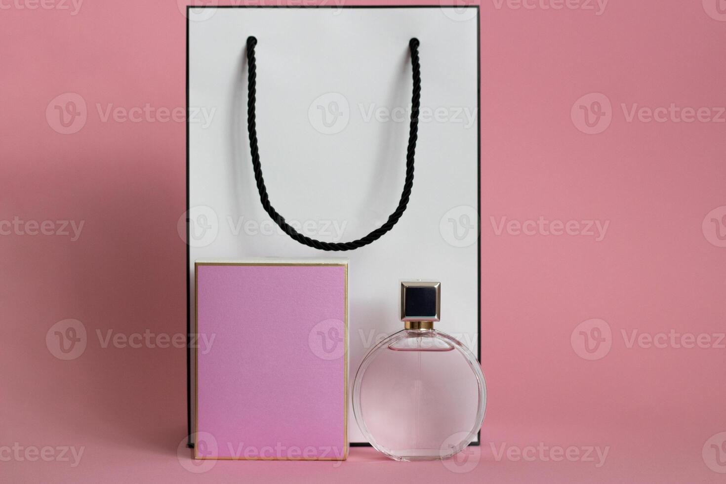 Perfume bottle from a pink box on an isolated background with mockup and copyspace photo