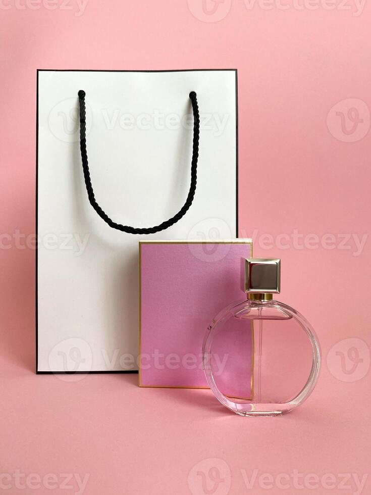 Perfume bottle from a pink box on an isolated background with mockup and copyspace photo