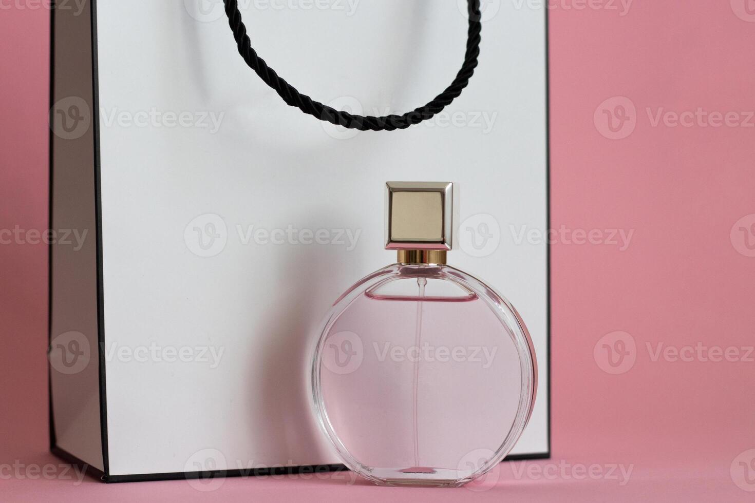 Perfume bottle from a pink box on an isolated background with mockup and copyspace photo