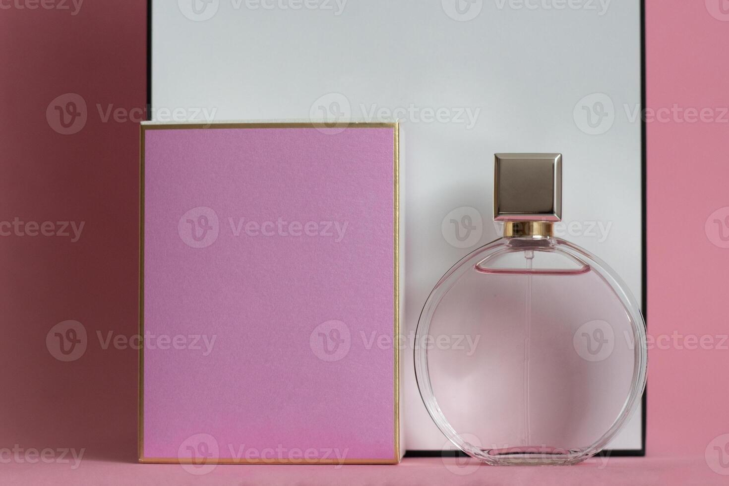 Perfume bottle from a pink box on an isolated background with mockup and copyspace photo