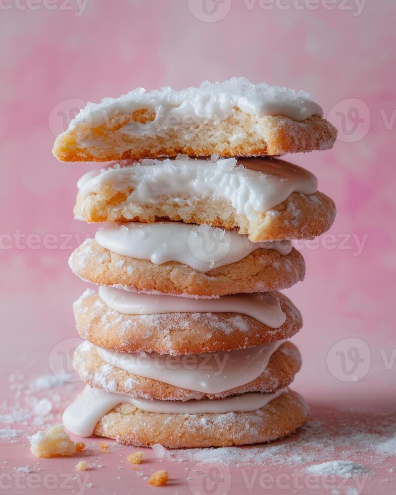 Stack of Sugar Cookies With White Glaze on Pink Background photo