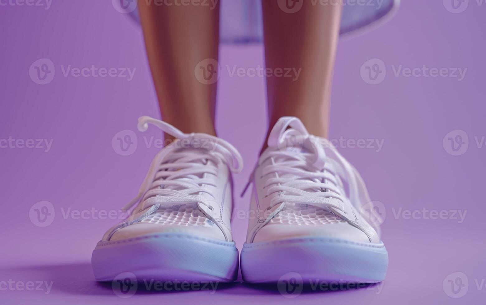 A Pair of White Sneakers Stand Ready for a Day of Exploration on a Purple Background photo