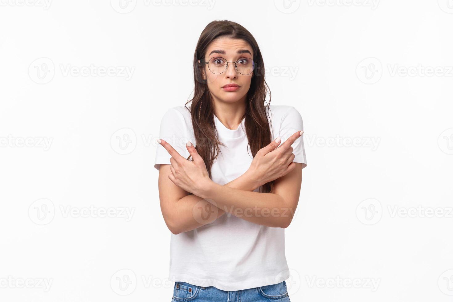 Waist-up of indecisive, clueless good-looking caucasian female in glasses, cant decide, pointing fingers sideways left and right, shrugging and looking confused, asking for help in taking decision photo