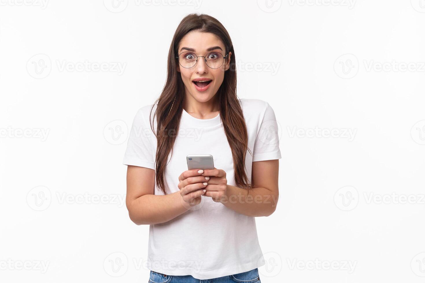 Communication, technology and lifestyle concept. Portrait of impressed, excited pretty girl receive great news, awesome notification from shopping app, gonna buy, hold mobile phone photo