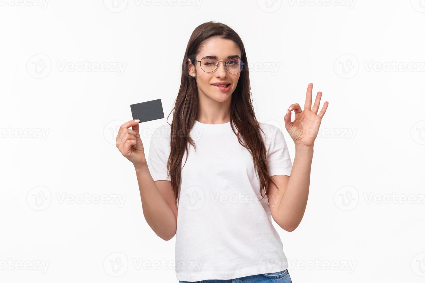 Got everything under control. Good-looking carefree, calm woman assure you all good, no problem cause she have credit card, wink and bite lip encourage all ok, white background photo
