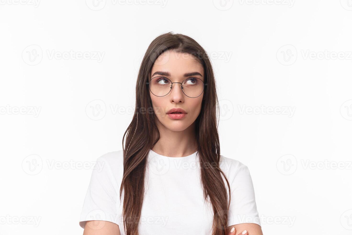 Close-up portrait of annoyed, arrogant young brunette pretty woman in glasses, rolling eyes up from irritation, tired of listening stupid conversation, standing white background bothered photo
