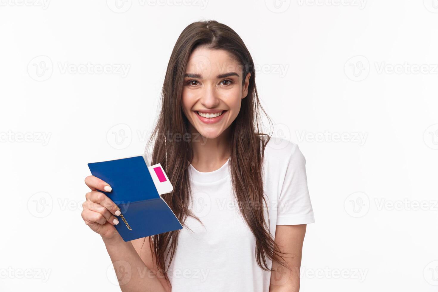 Travelling, holidays, summer concept. Close-up portrait beautiful young woman with long hair, traveller sitting in airport, holding passport and airplane ticket, going for vacation, white background photo