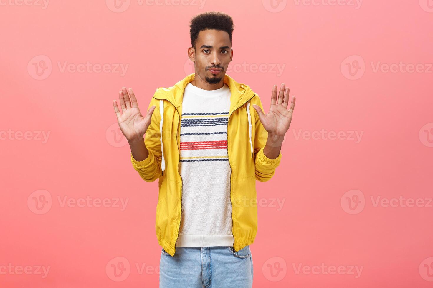 Man feeling intense not liking bad idea of friend rejecting in participating suspicious deal raising palms in refusal gesture staring concerned and displeased at camera over pink background photo