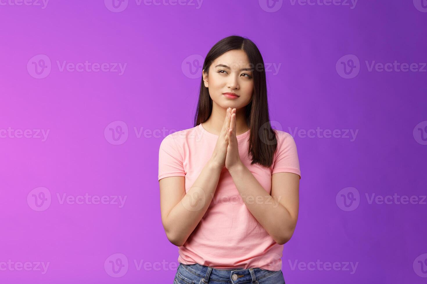 Cunning smart good-looking asian woman rubbing hands together scheming, squinting suspicious focused have evil plan, look upper left corner, sly idea, stand purple background photo