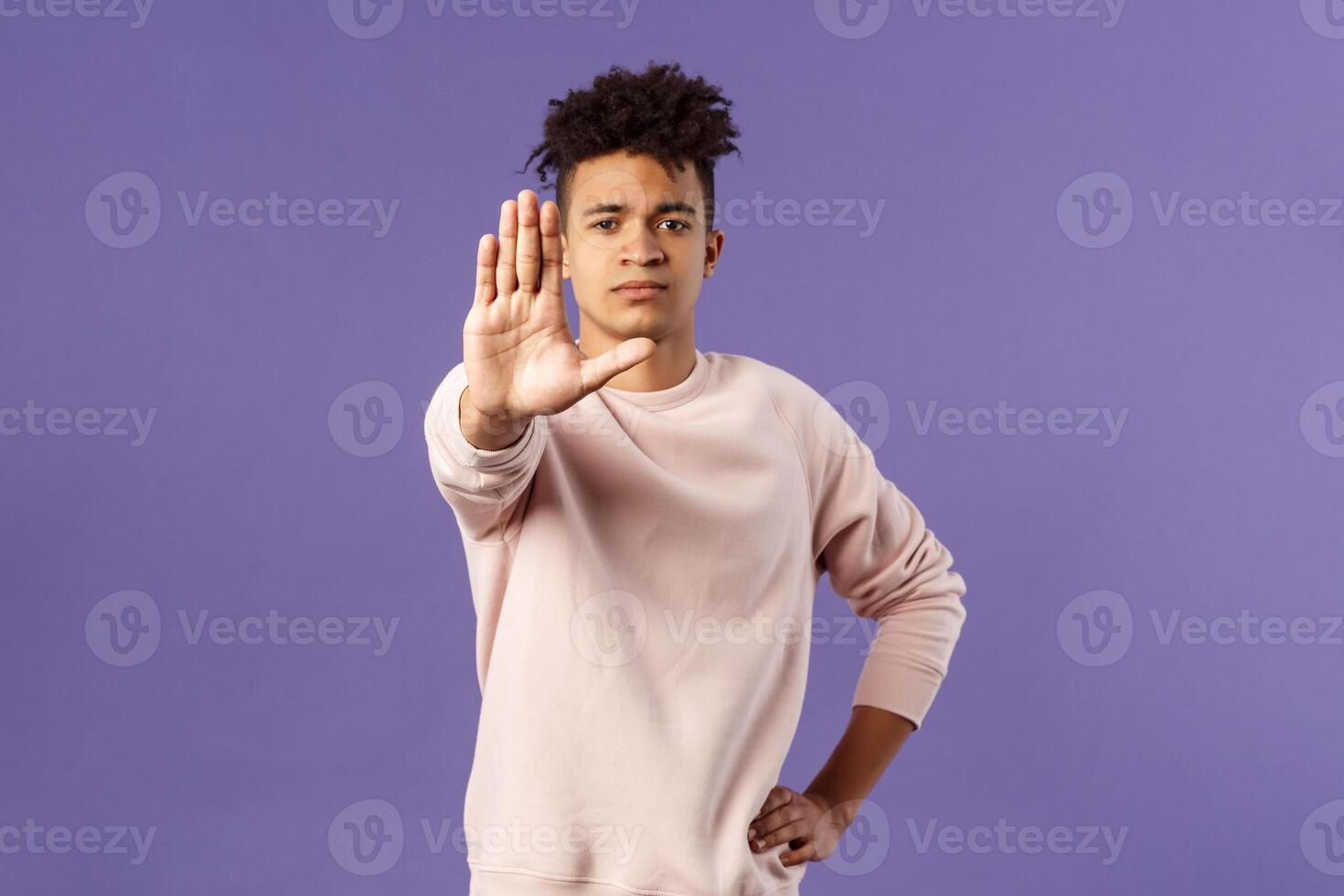 Stop right there, keep distance dont come closer. Portrait of serious-looking young sound-minded hispanic guy trying prevent something bad, show warning gesture, prohibit or forbid photo