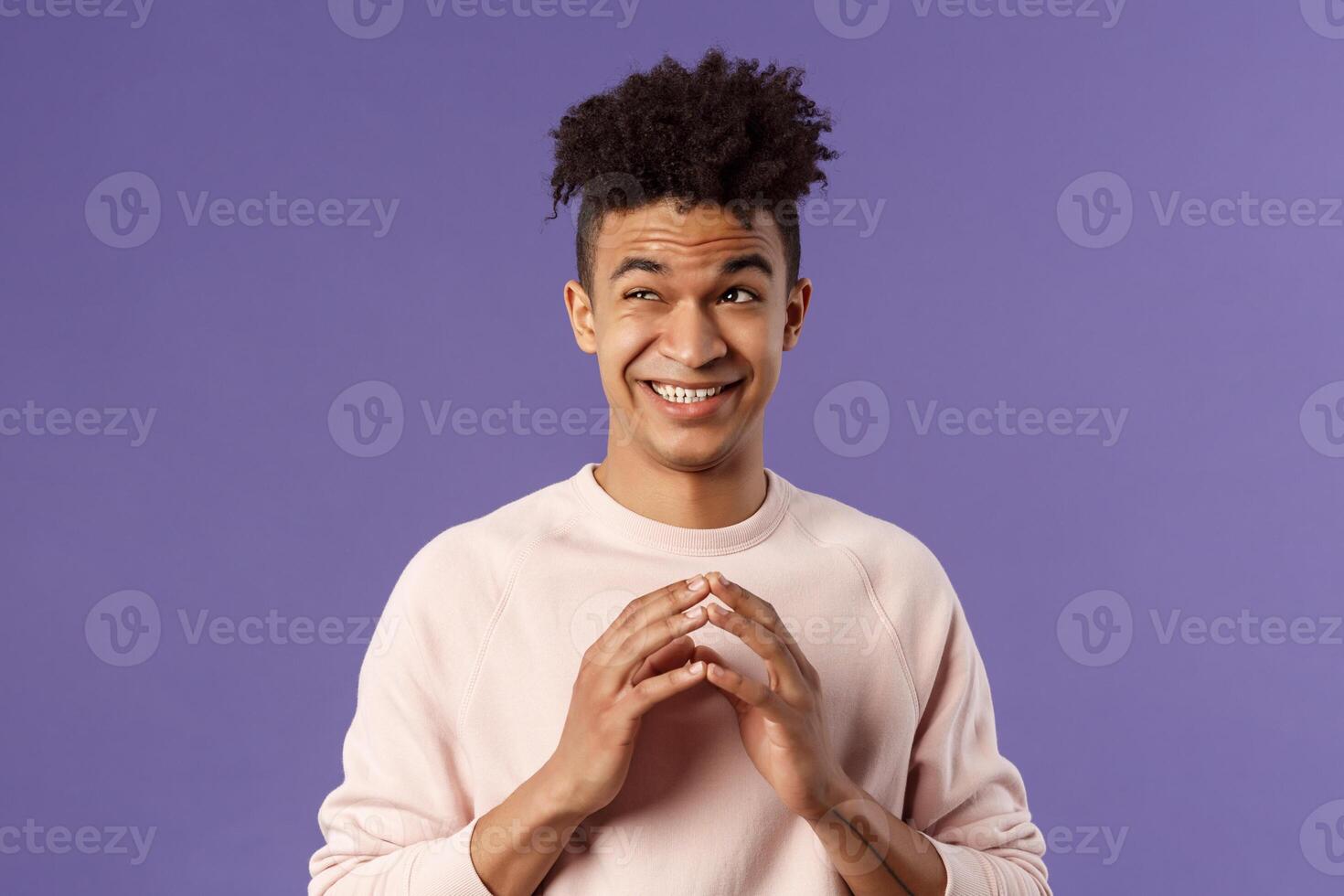 Close-up portrait of creative young hispanic guy steeple fingers while making-up great plan or joke, look away daydreaming, scheming something, have idea, stand purple background photo