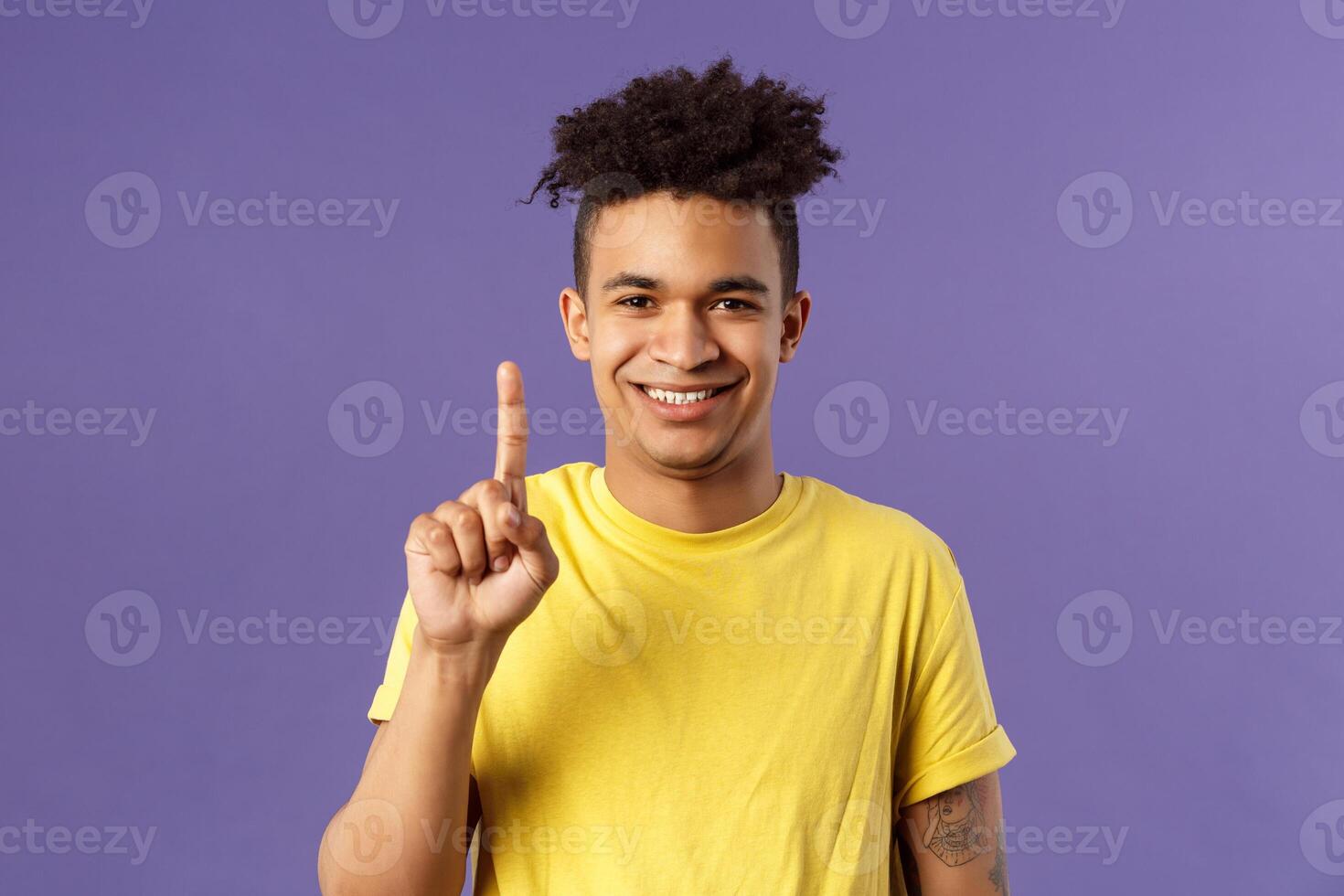 Close-up portrait of funny young teenager, guy picking nose showing index finger and giggle, gagging over his own joke, being nasty and disgusting, standing purple background photo