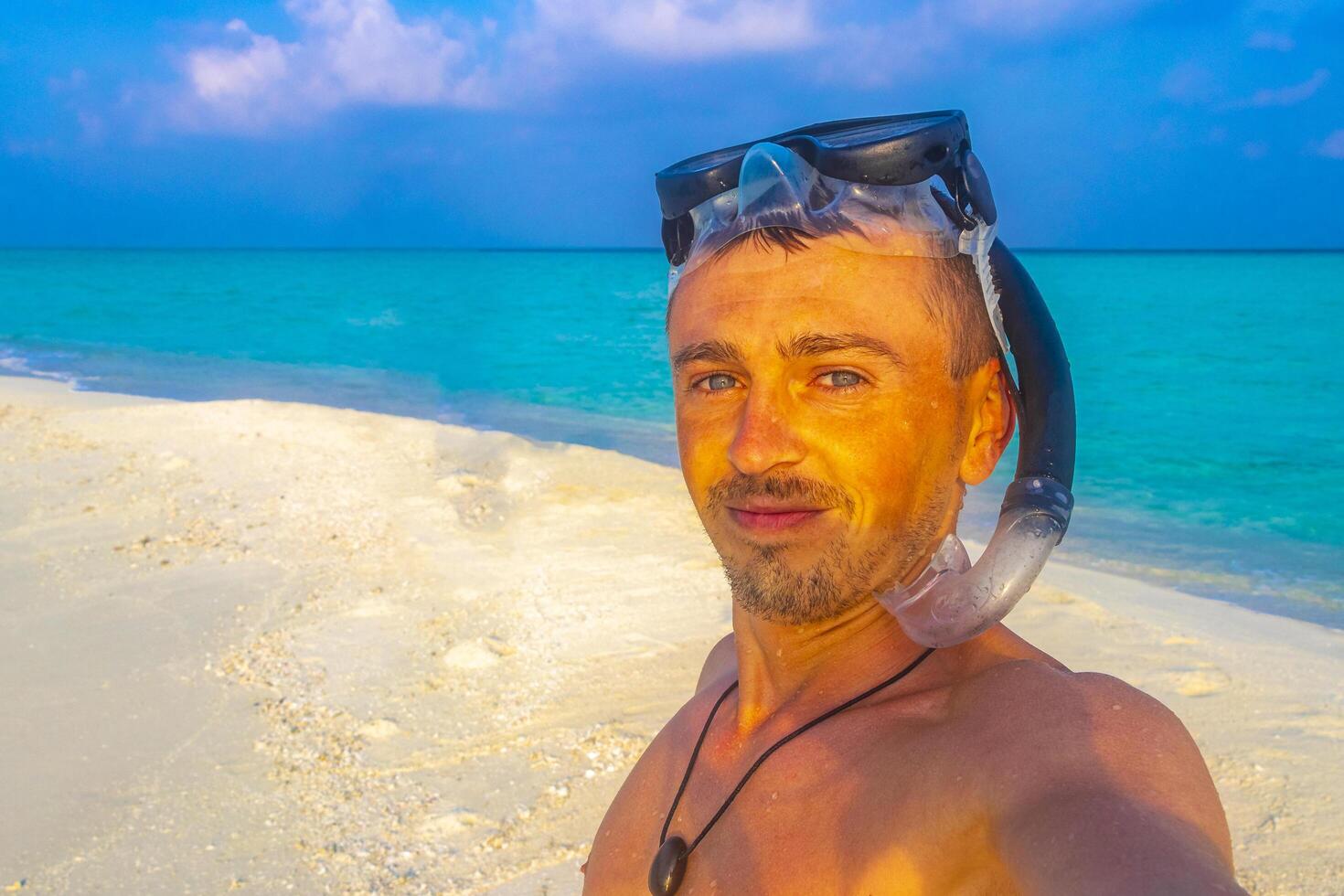 Man with snorkeling equipment fins and snorkeling mask Maldives. photo