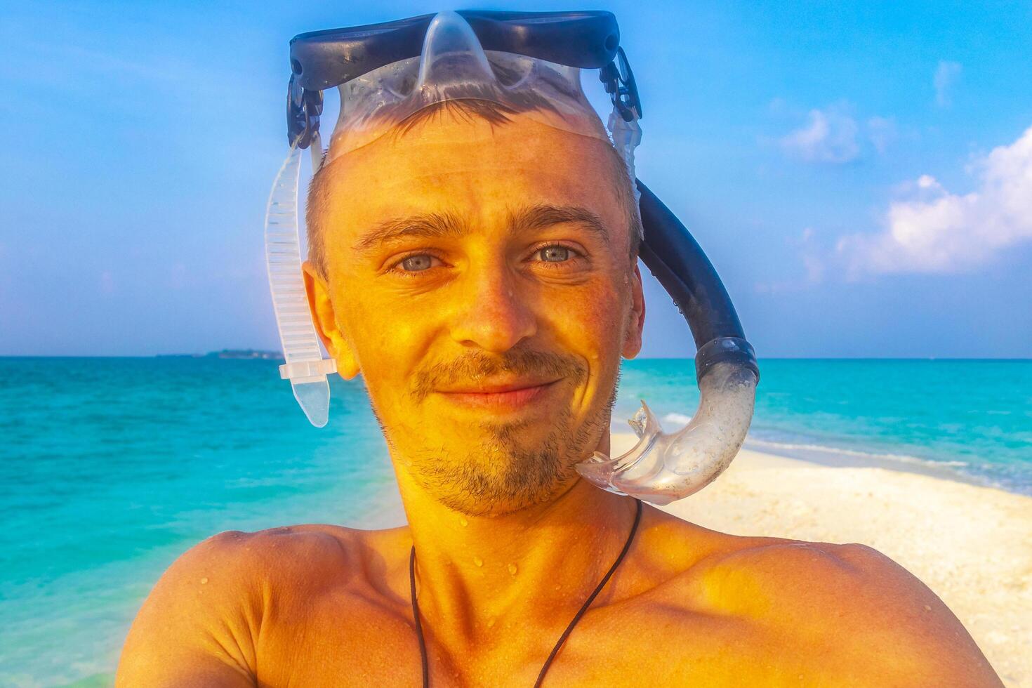 Man with snorkeling equipment fins and snorkeling mask Maldives. photo