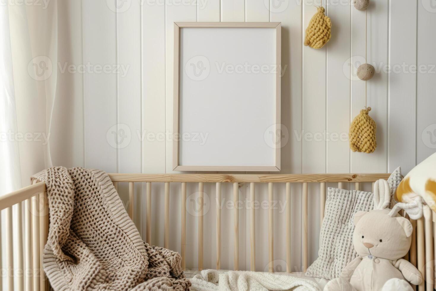 Cozy nursery with stuffed toys, an empty frame and a wall with floral and animal designs photo