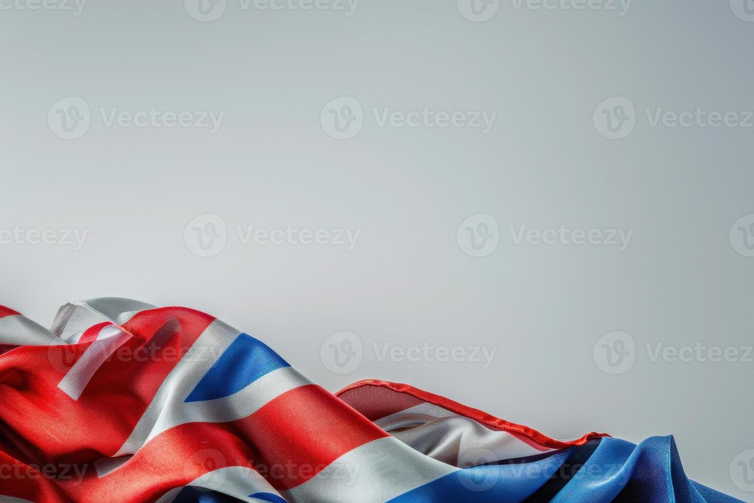 A neatly folded Union Jack rests gracefully on a smooth white surface, showcasing its vibrant colors in a tranquil setting. photo