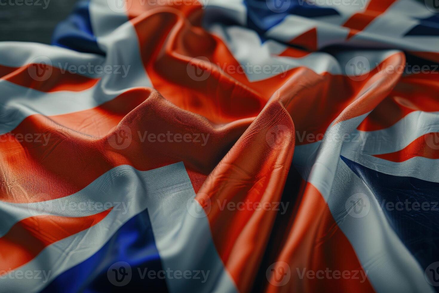 A meticulously arranged UK flag lies gracefully folded against a pristine white surface, showcasing its vibrant colors and intricate design. photo