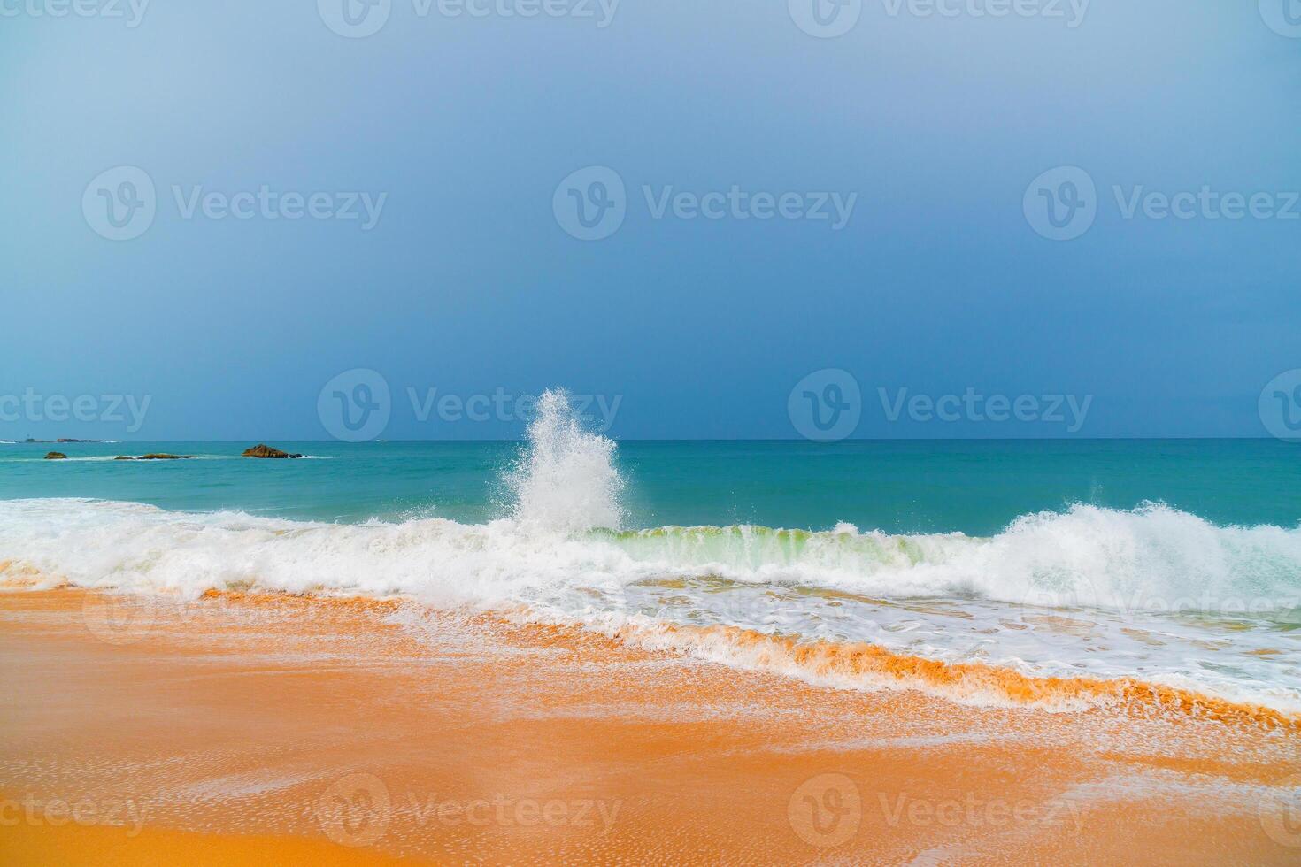 Foam wave, running on the sandy shore. photo