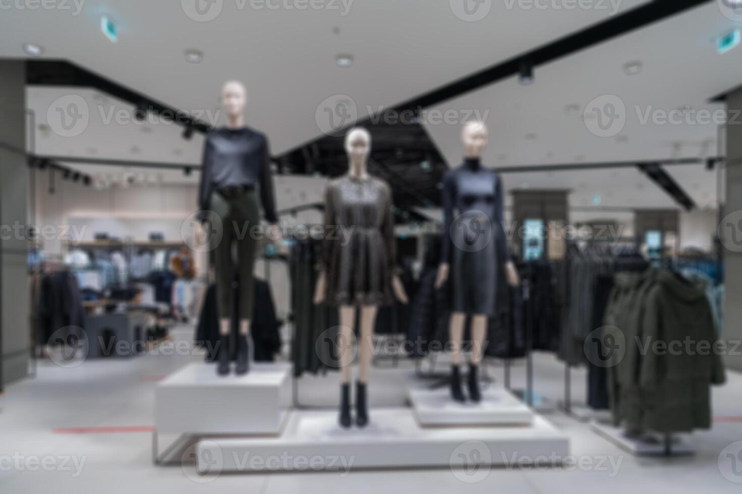 blurry interior of the store of women's clothing. Mannequins in modern costumes. photo
