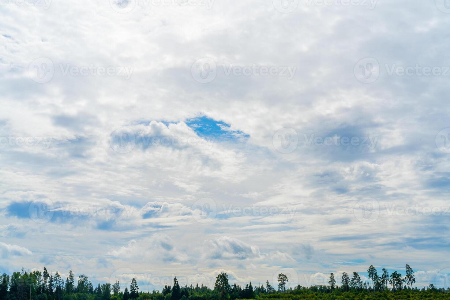 White clouds in the blue sky. Summer cloudy weather. Light natural background. photo