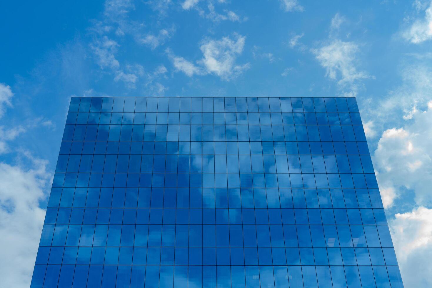 Moscow. Russia. June 15, 2020. Glass high-rise building. Reflection of clouds and sky in mirrored windows. Modern city. photo