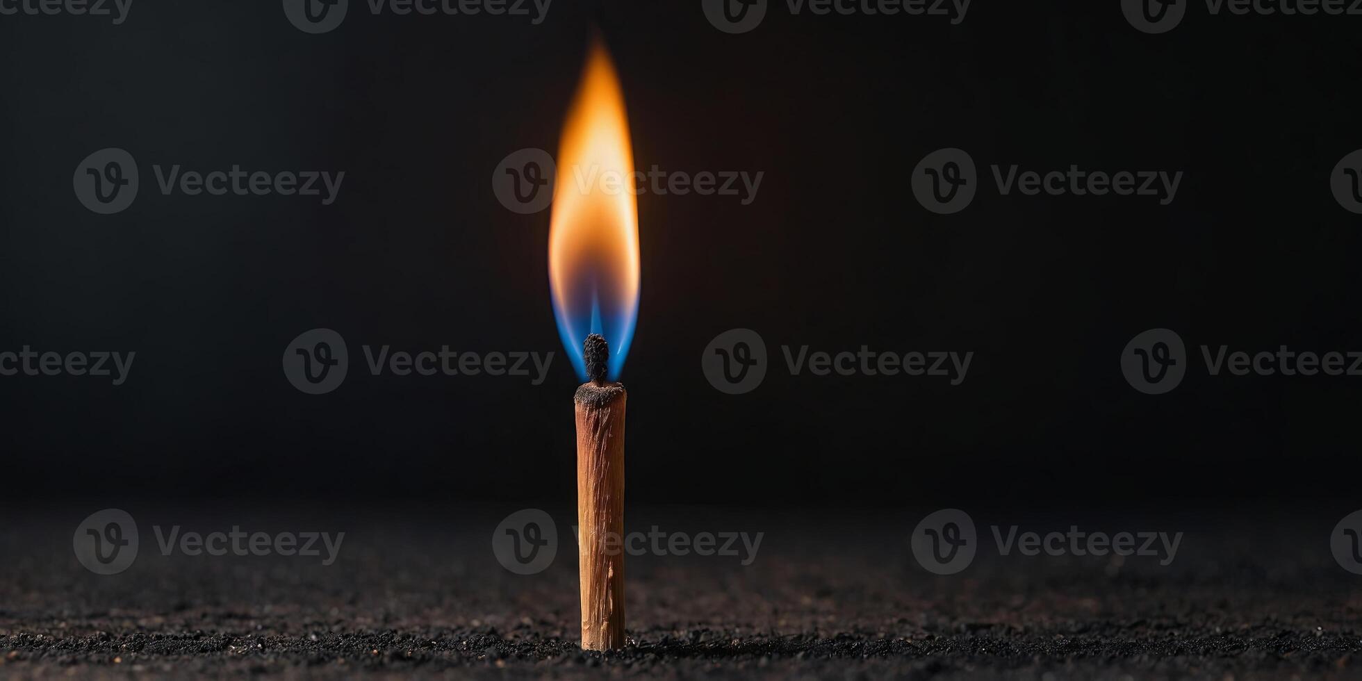 A close-up of a burning wooden match on black background Match head with burning gray at the end, flames, copy space Creative banner of energy, fuel industry. photo