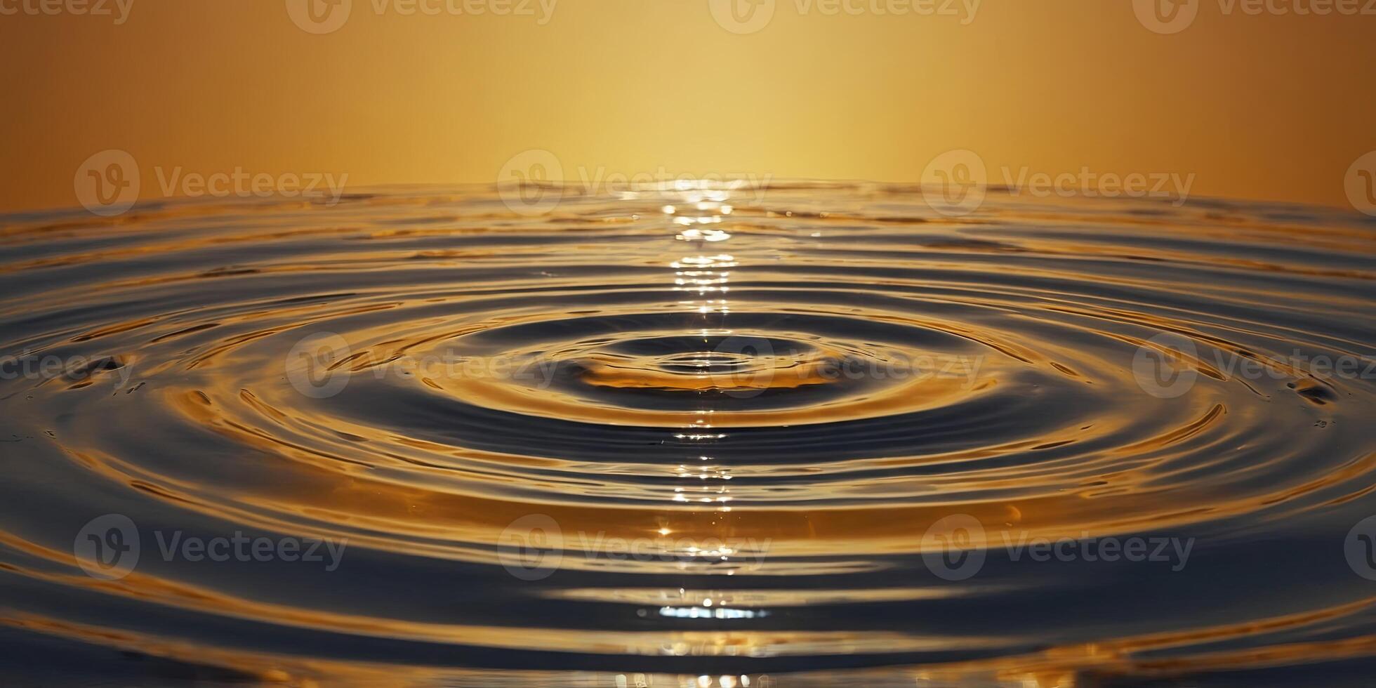 A yellow-orange gradient background with a circular water ripple in the middle The entire picture is presented from above at eye level with a minimalist composition. photo
