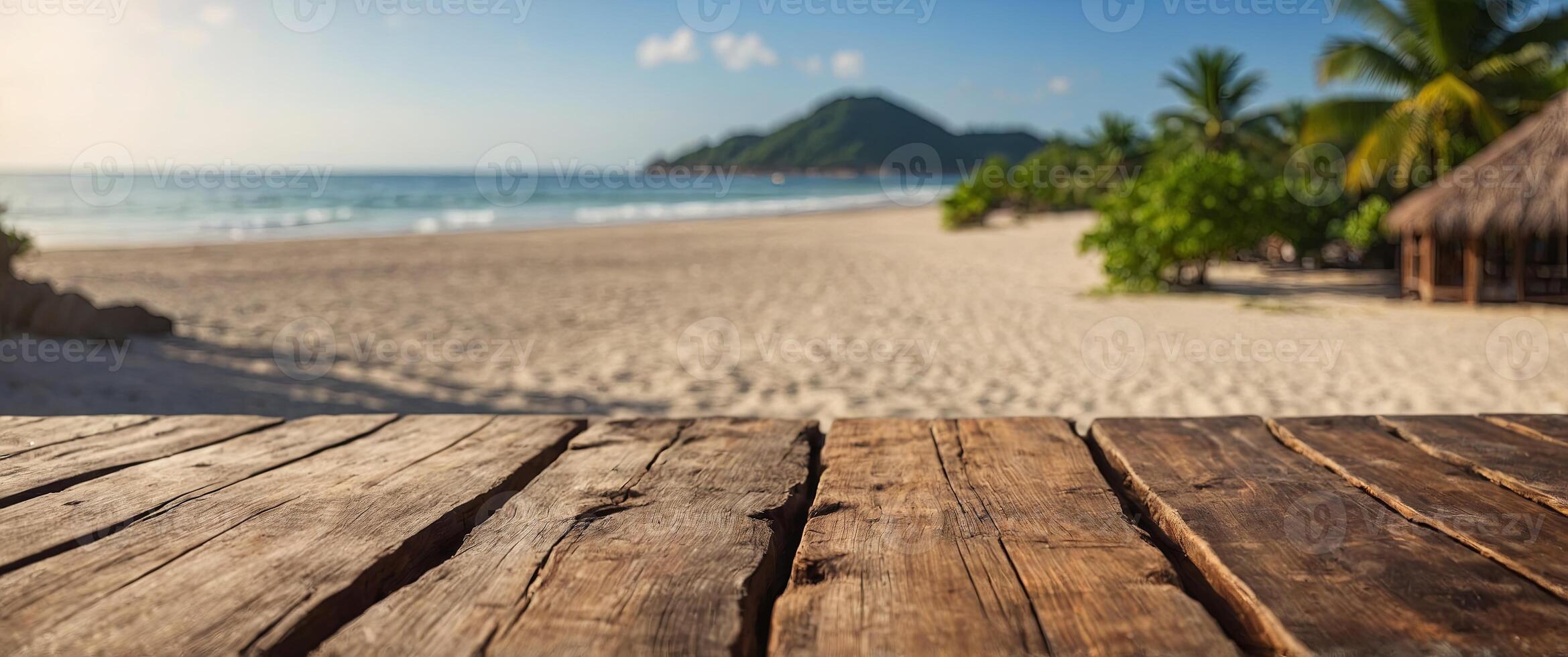 A wooden table top with a blurred tropical beach background for product display presentation, suitable for a summer vacation concept. photo