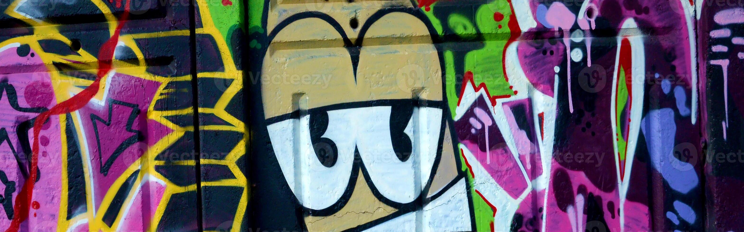 Colorful background of graffiti painting artwork with bright aerosol outlines on wall. Old school street art piece made with aerosol spray paint cans. Contemporary youth culture photo