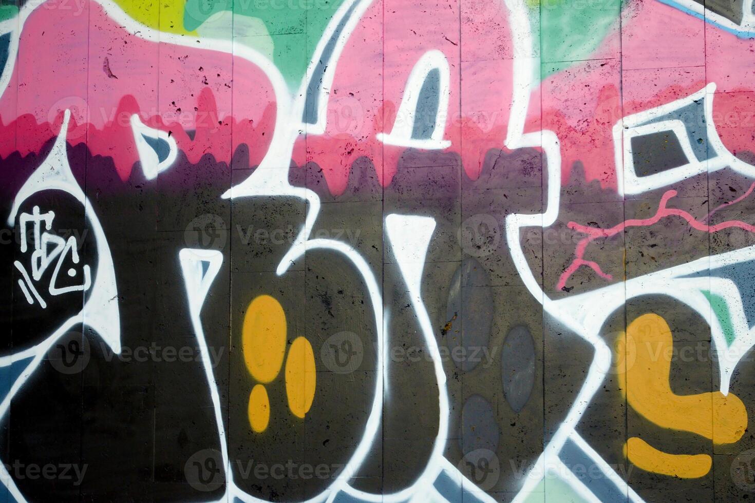 Colorful background of graffiti painting artwork with bright aerosol outlines on wall. Old school street art piece made with aerosol spray paint cans. Contemporary youth culture photo