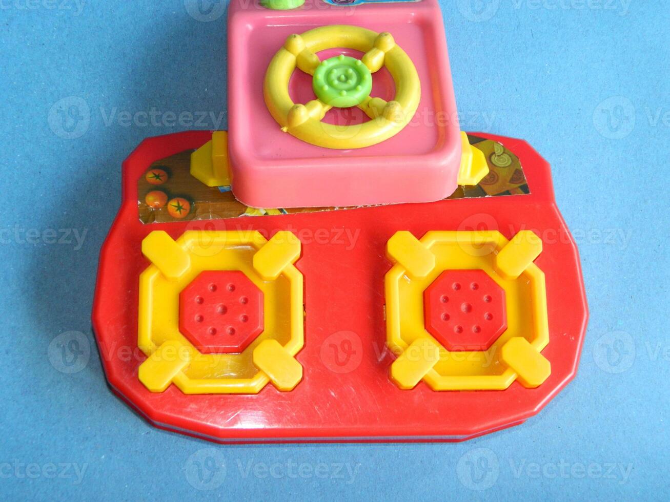 Macro photo of children's cooking toys with a blue background