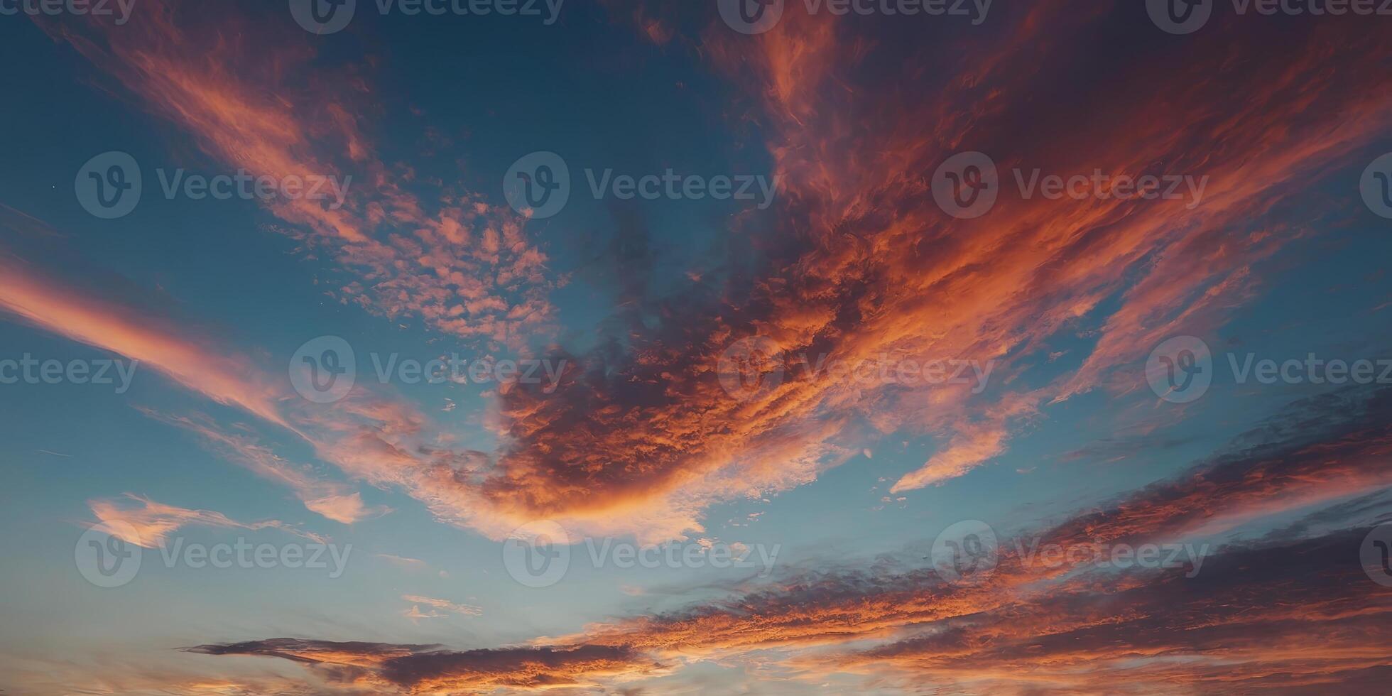 Closeup of the sky as it transforms from a clear pale blue to a canvas of fiery oranges and pinks. photo