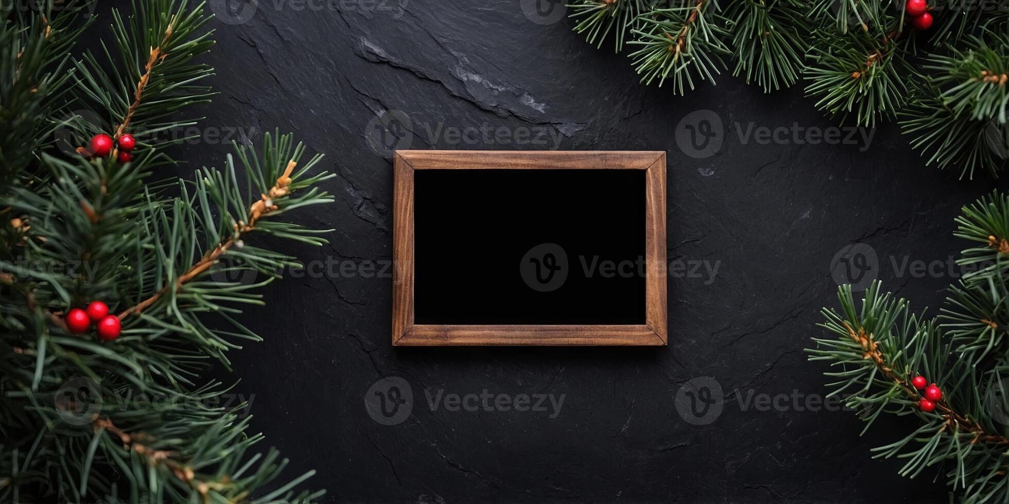 Festive Christmas frame placed on a black stone with a pine branch. photo