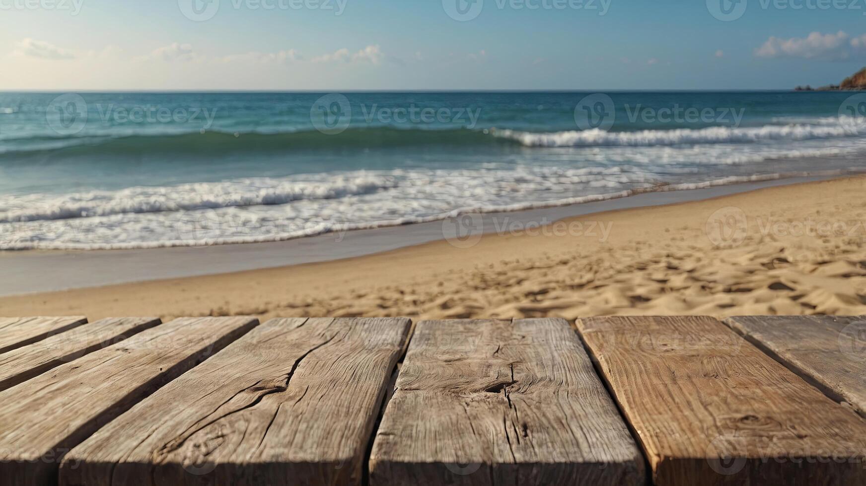 Empty wooden table on sandy beach with blurred ocean background, ideal for product display. photo