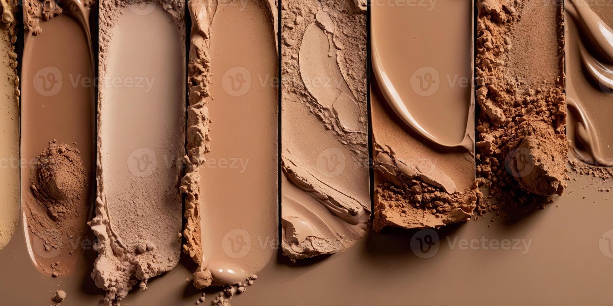 Foundation swatches from light to dark with a mix of powder and liquid foundation products. photo