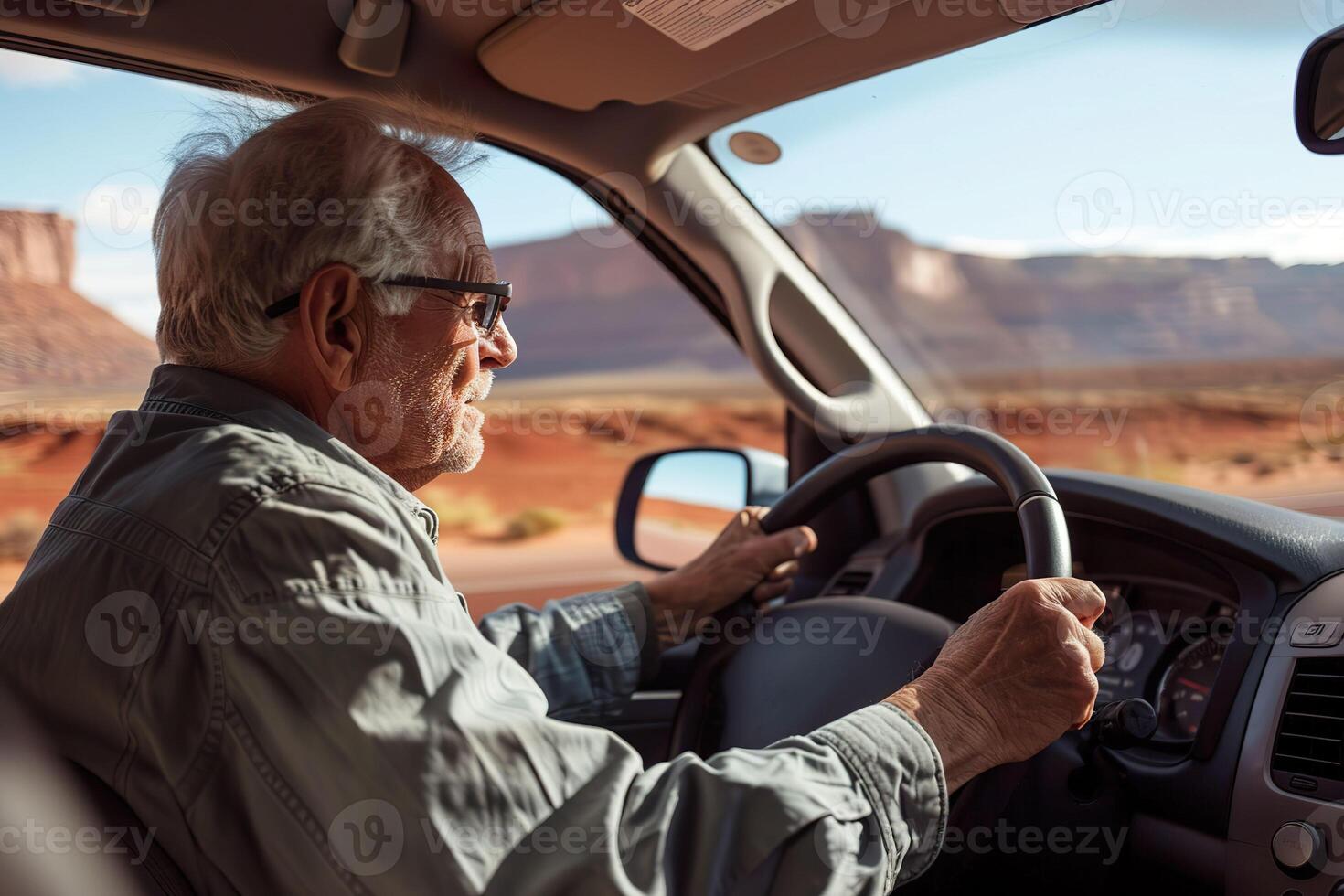 Elderly Man Driving Through Desert photo