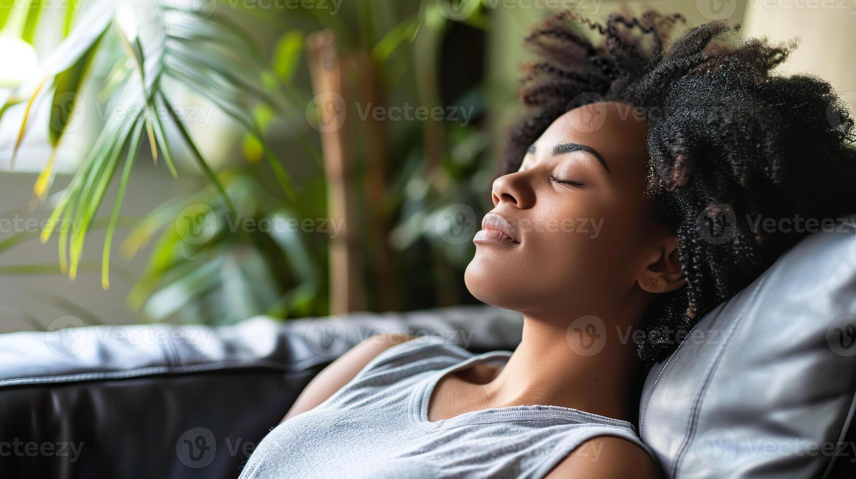 A woman enjoys a peaceful moment of relaxation on a couch. photo