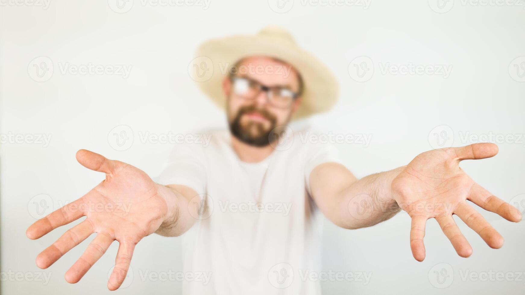 portrait of handsome bearded man with straw hat and glasses smiling, hand gesture no, wearing white shirt , isolated on white background photo