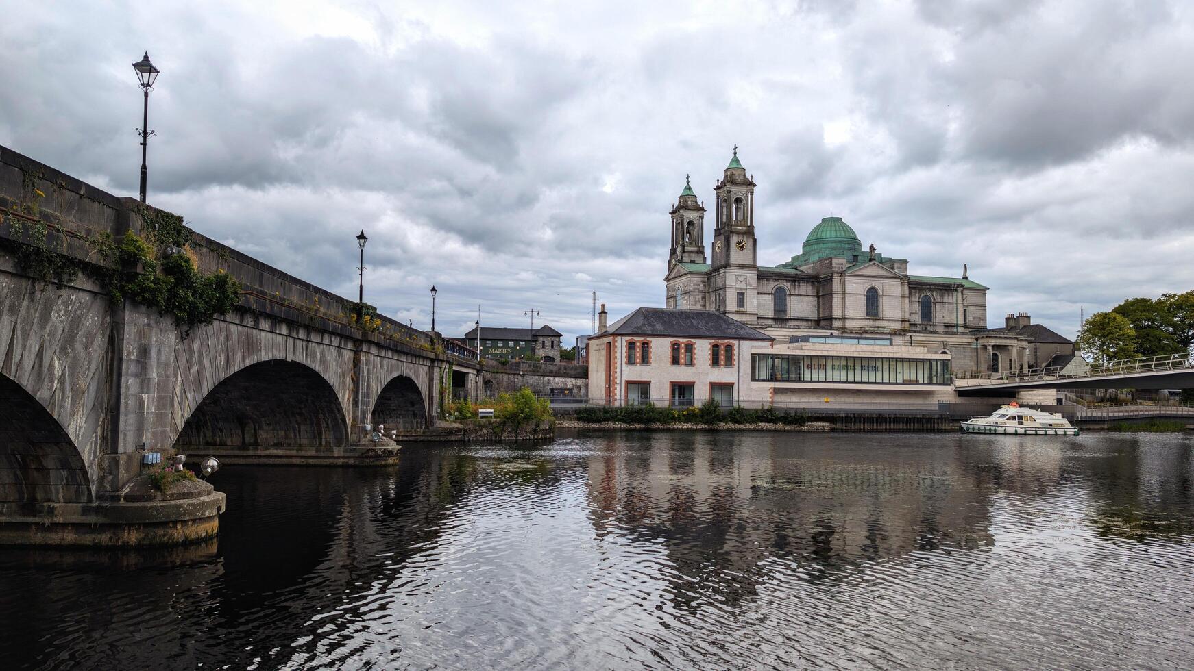 Beautiful old cityscape scenery, Church of Saints Peter and Paul by Shannon river at Athlone, town in Westmeath, Ireland, landmark and architecture background photo