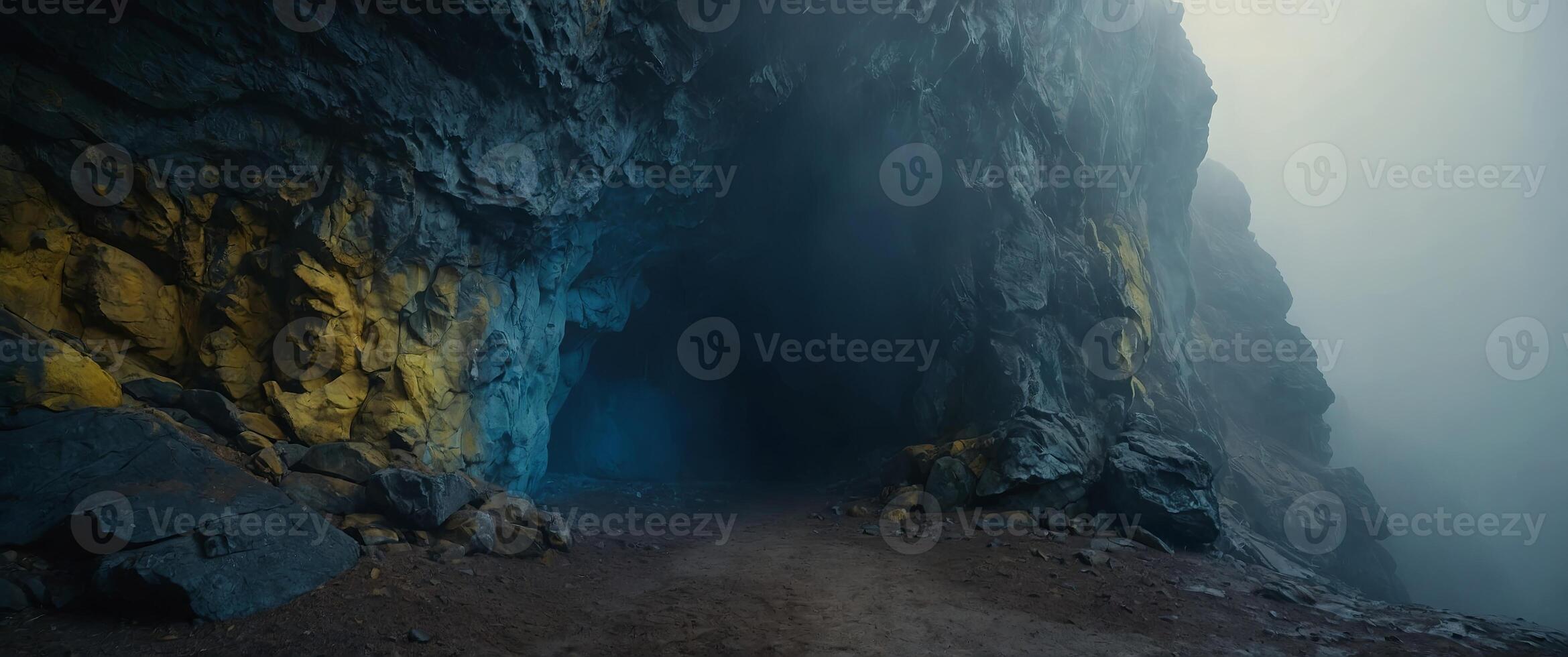 Blue and yellow smokey and foggy cave entrance Large stone cave Misty and foggy rock formation. photo