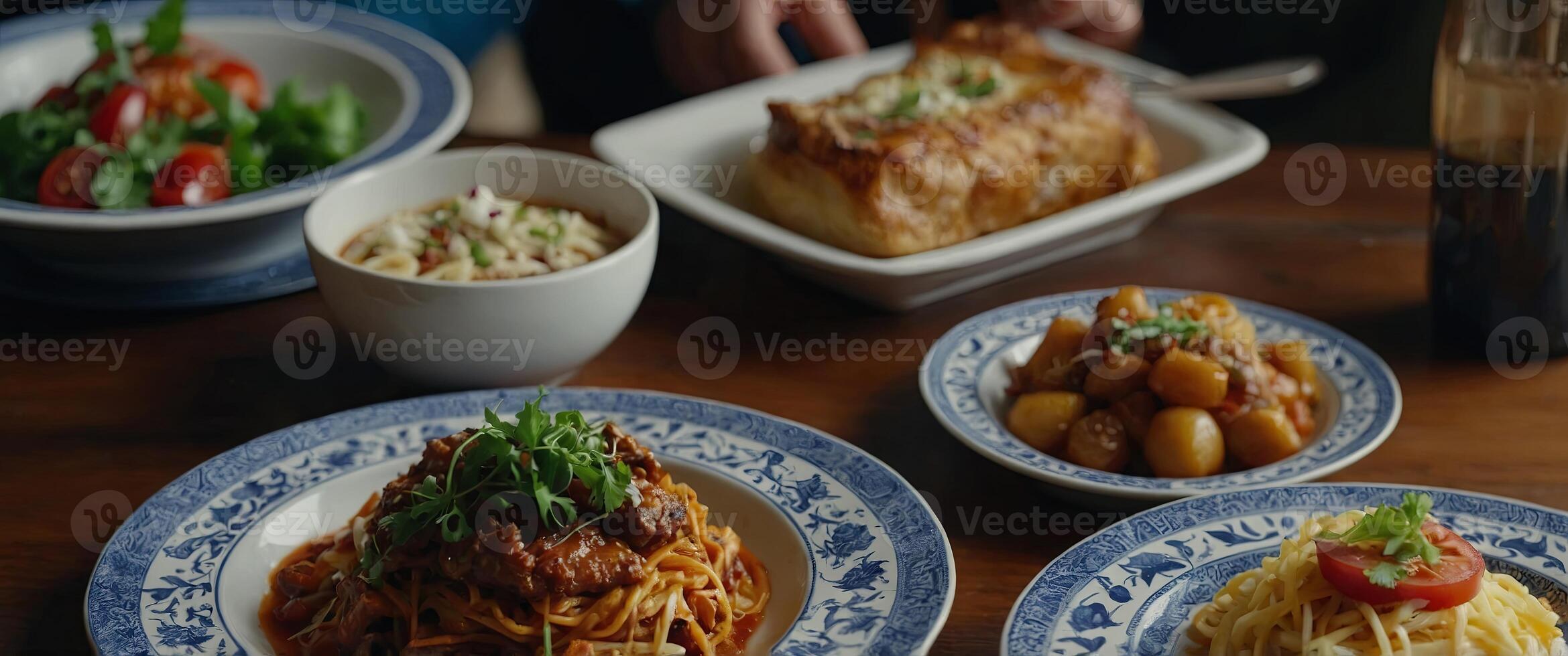 Delicious food served on various plates on a table. photo
