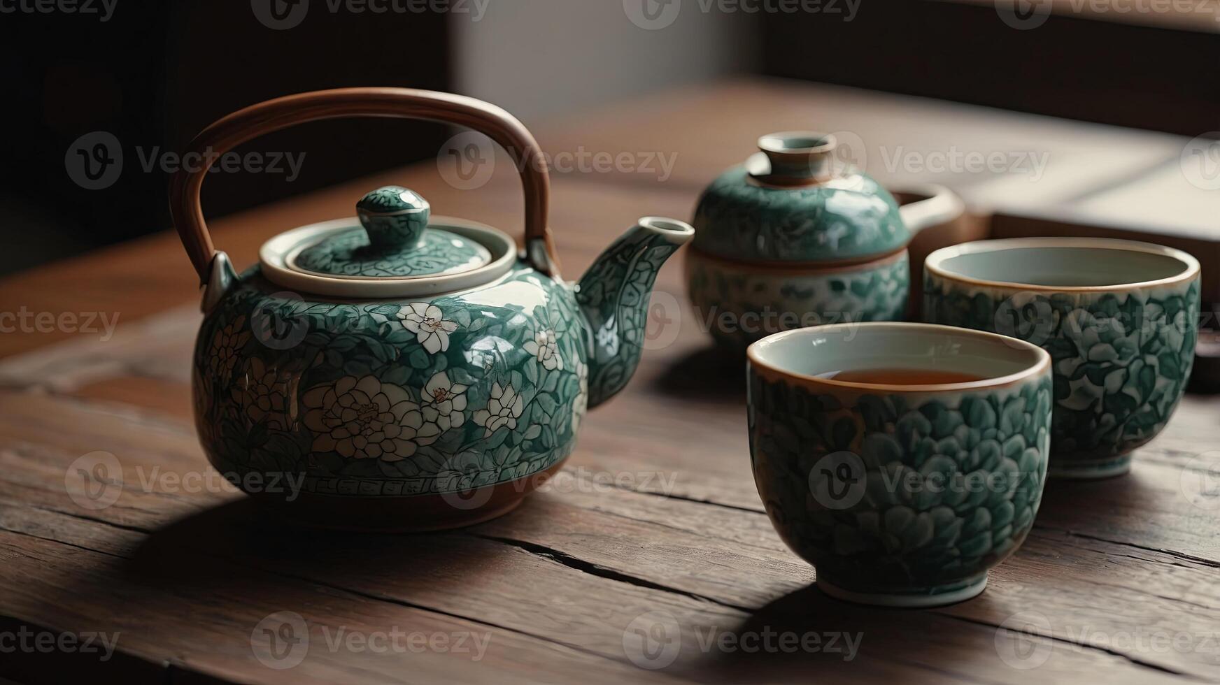 Tea ceremony traditional teapot and ceramic cups on wooden table. photo