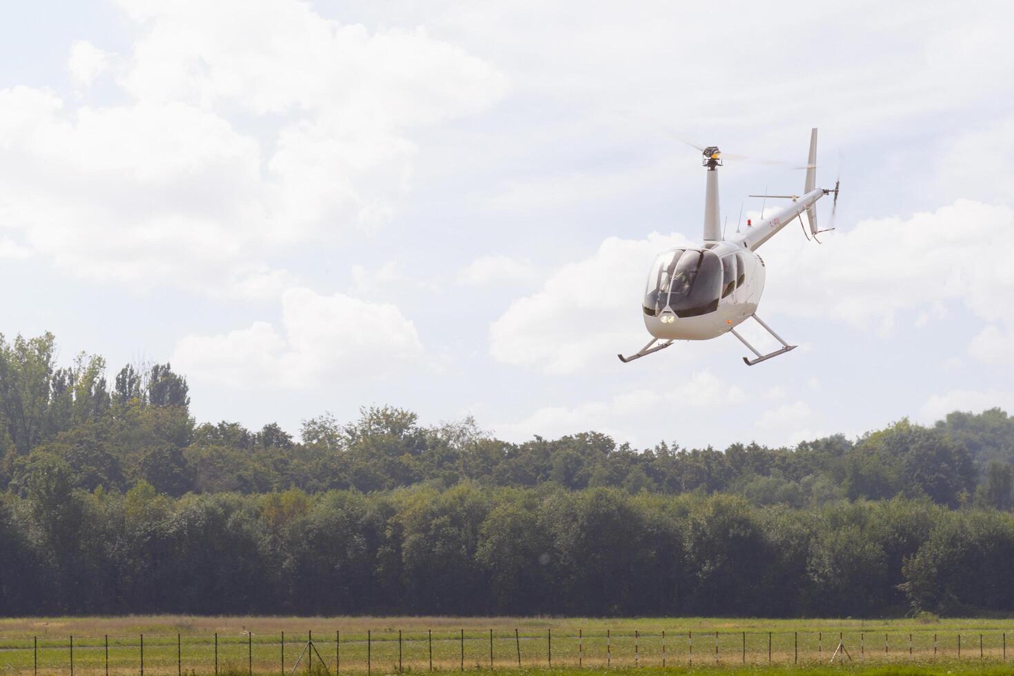 Sint-Truiden. Limburg - Belgium 03-09-2023 Robinson R44 Raven 2 in fly. Public airshow of vintage aircraft at the Sint Truiden Aero Club photo