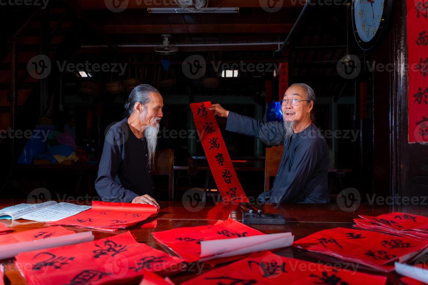 old scholars writing calligraphy at lunar new year. Calligraphy is a popular tradition during Tet holiday. Text in photo mean Happy New Year and Peace.