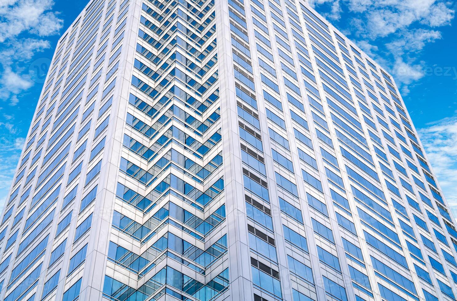 Skyscraper glass building of corporate headquarters in the downtown business area. Towering facade and windows embodying sleek, modern office environment. Financial institution. Modern architecture. photo
